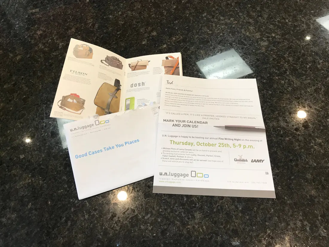 Envelope-stuffed direct mail kit for a luggage retailer: catalogue, letter and printed envelope